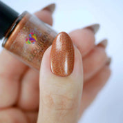 Amber vegan quick-dry nail polish in warm bronze with a high-shine finish, 10-free and cruelty-free.