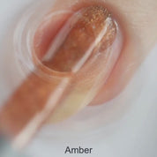 Amber vegan quick-dry nail polish in warm golden-orange with a high-shine finish, 10-free and cruelty-free.