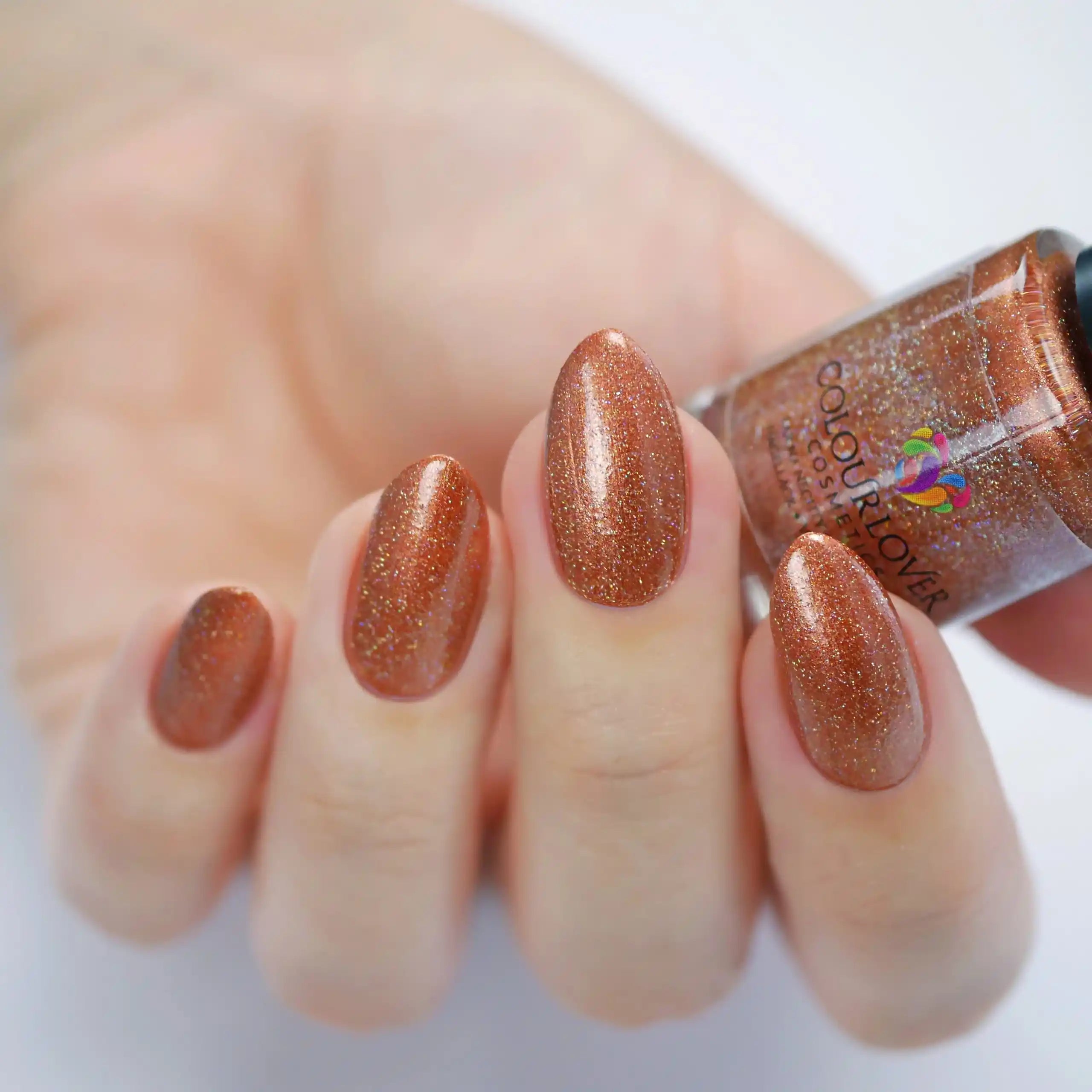 Amber vegan quick-dry nail polish in warm bronze with a high-shine finish, 10-free and cruelty-free.