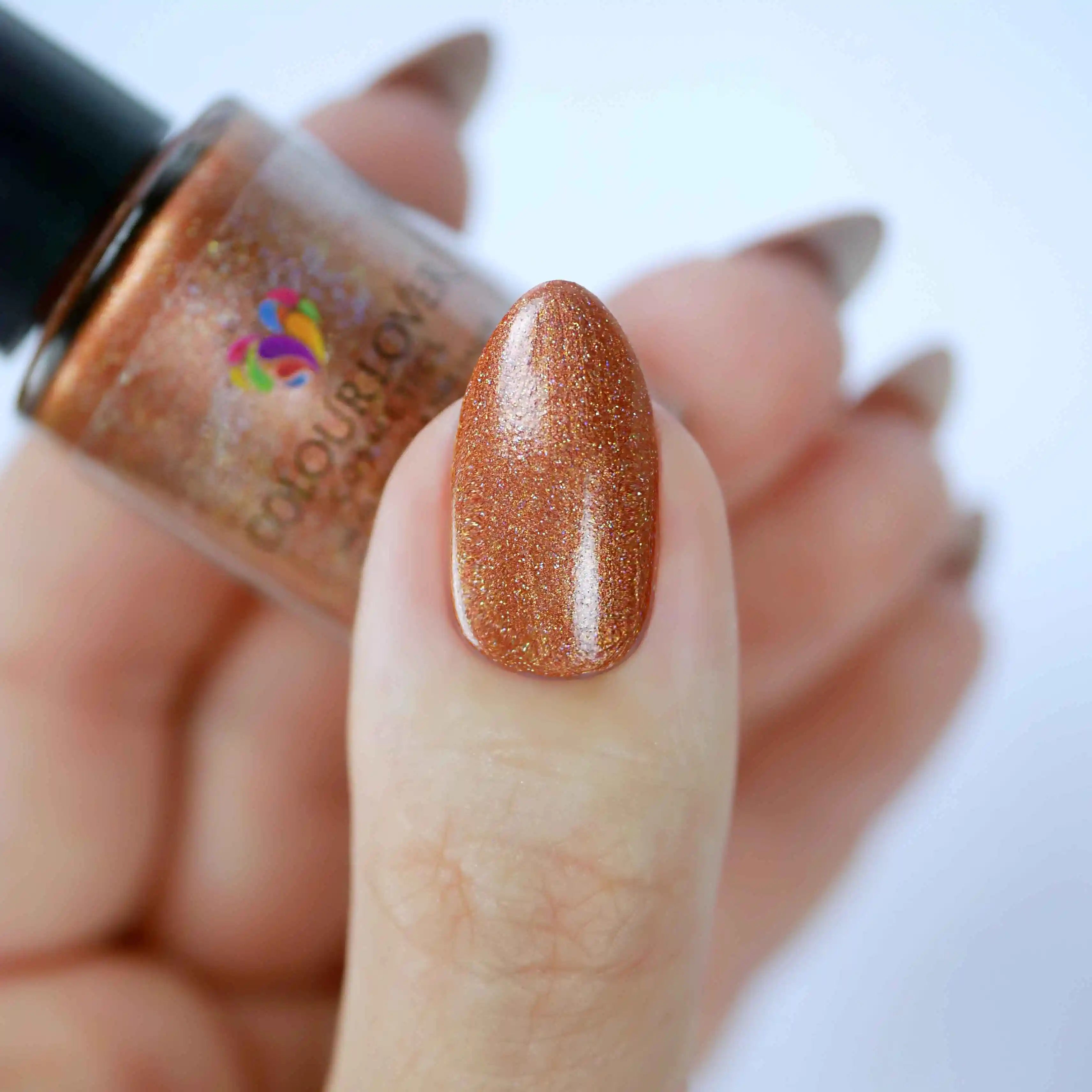 Amber vegan quick-dry nail polish in warm bronze with a high-shine finish, 10-free and cruelty-free.