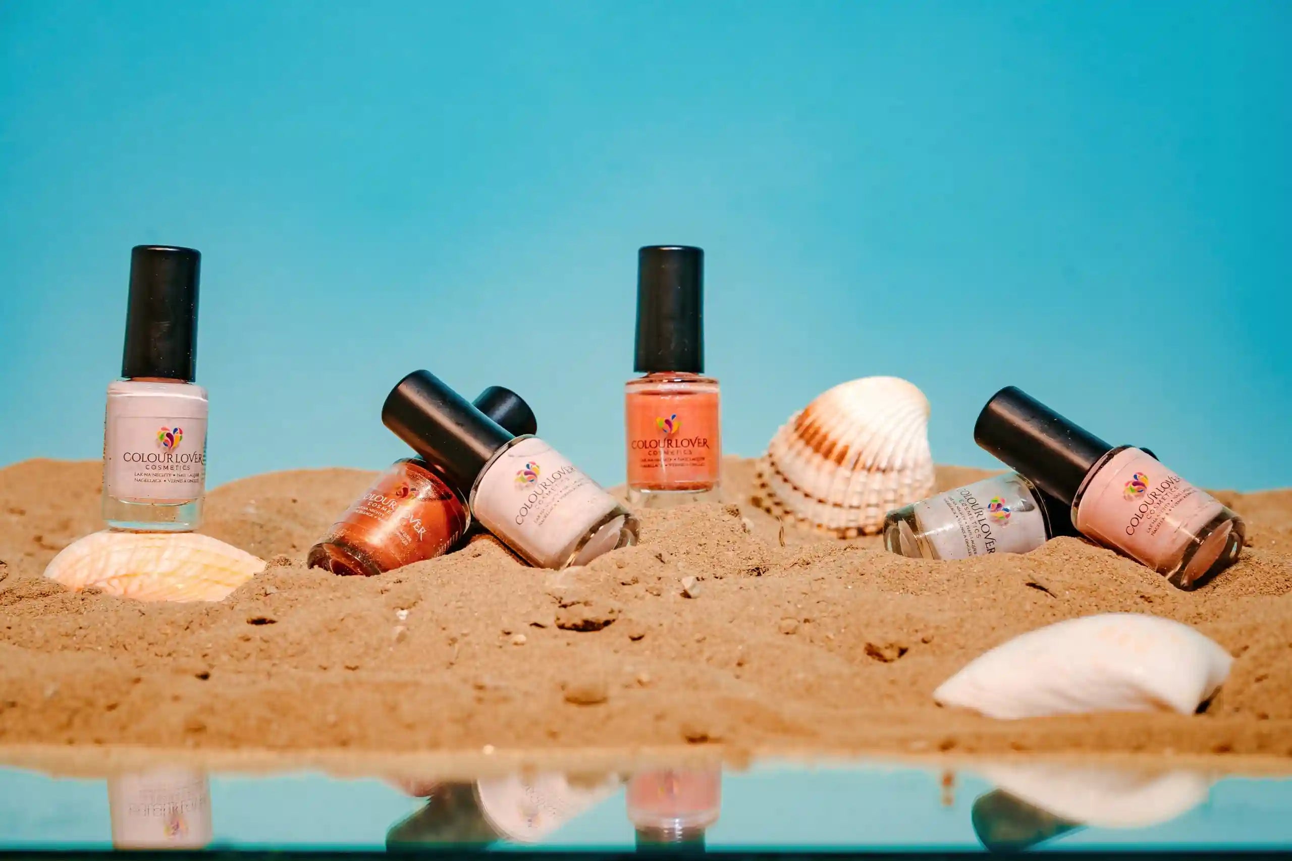 Soft nude and bronze shades with a holographic and metallic finish, perfect for summer manicures.